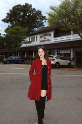 a lady in a black strapless dress and a red tweed jacket